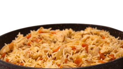 Tasty pilaf with chicken in a frying pan.