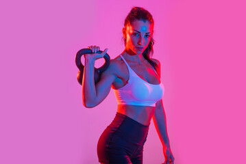Sportive beautiful woman training with athletic body and sportswear doing workout, colorful...