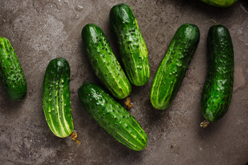 Fresh cucumbers on dark background.