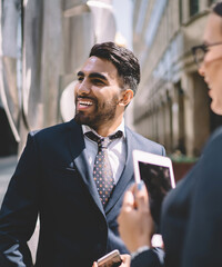 positive economists smiling outdoors while talking about conference 