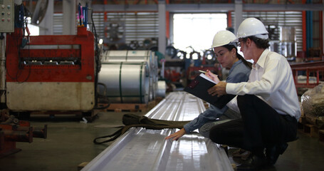 worker or engineer working in factory with safety uniform , safety hat and safety glasses , image is safety concept or happy workplace