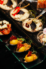 A pleasant evening with a delicious appetizer, a buffet table with appetizers and a set of canap s with ham, bruschetta, pear, cheese, raspberries and other sweets.