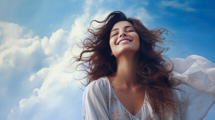 Brunette woman breathing fresh air and feeling the wind with nice clouds in the background.