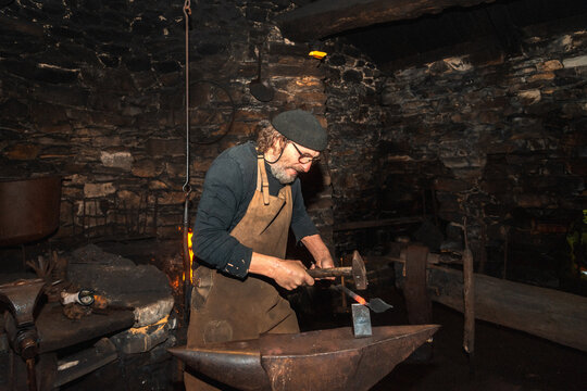 Blacksmith at work in historic workshop