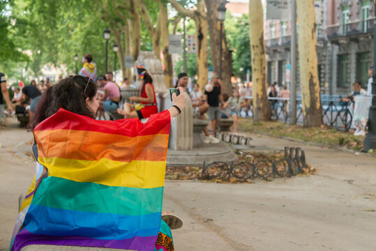 Woman with pride flag capturing a moment