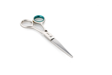 Grooming scissors. Scissors for cutting people and pets. Closed scissors on a white isolated background. Close-up