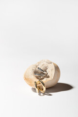 Jewelry made of gold and silver on a white background. Stylish compositions with hard shadows and natural stones. 