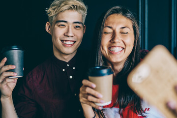 positive japanese friends spending free time together and taking pictures