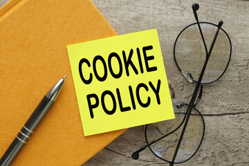 Cookie Policy on the background of the table on a yellow sticker.
