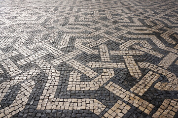 Geometric Pattern of Traditional Mosaic Tiles on Pavement in Lisbon, Portugal.