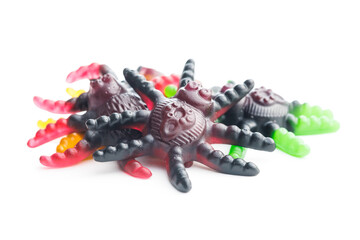 Scary sweet jelly spiders. Halloween candies isolated on white background.