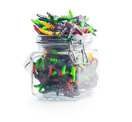 Scary sweet jelly spiders. Halloween candies in jar isolated on white background.