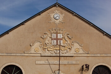 Facade of a fishmonger's shop.Facade with clock, coat of arms and inscription.