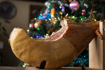 Whole Serrano ham on a Christmas tree background
