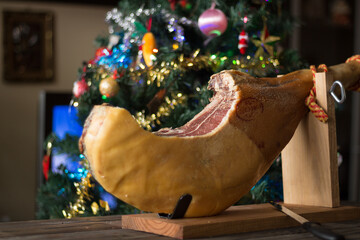 Whole Serrano ham on a Christmas tree background