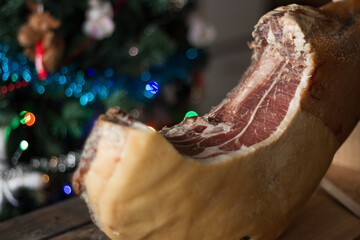 Whole Serrano ham on a Christmas tree background