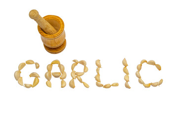 Garlic letters and garlic press written with garlic grains on a white isolated background
