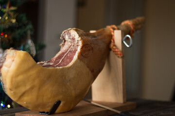 Whole Serrano ham on a wooden table