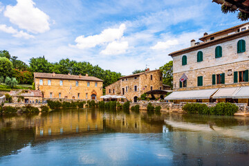 Fototapeta na wymiar Piazza delle Sorgenti and the Old Baths in the village Bagno Vignoni, in the Val d'Orcia in Tuscany, province of Siena, Italy. Popular for its hot springs. 