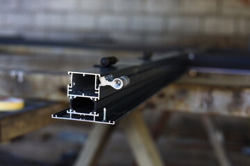 cut through the aluminum door profile during home production in the workshop