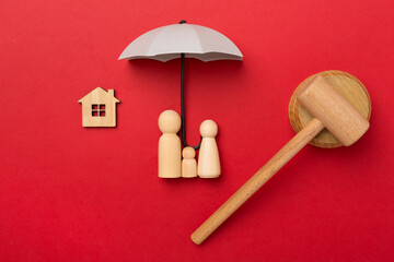 Wooden family figures with judge's gavel on color background,top view