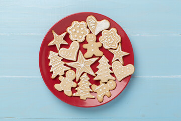 Cute homemade Christmas cookies with decor on wooden background,top view
