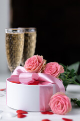 Beautiful surprise greeting for saint Valentine's or Women's Day, birthday or Anniversary for beloved. Fresh pink roses, gift box with sweets. White background. Holiday atmosphere