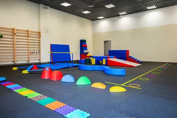 Zelfklevend Fotobehang Colorful Gymnastic Equipment in Modern Training Room Kid's Physical Development Zone © Uldis Laganovskis
