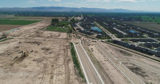 Aerial view of new residential neighborhood being built next to an existing residential community