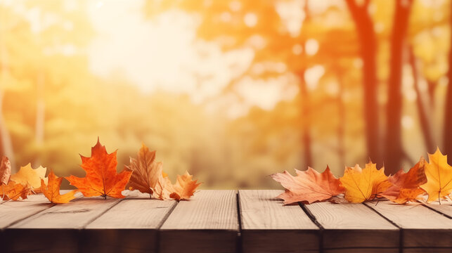 Maple leaves of autumn adorn a wooden tabletop, creating a natural background of falling leaves. A sunny autumn day unfolds in the park, showcasing the beauty of orange foliage. The scene forms a wide