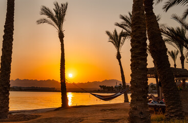 Orange Egyptian Sunset over the mountains and Red Sea resort with reflection, Soma Bay, Hurghada, Egypt