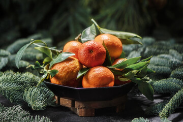 Bowl with fresh oranges on christmas background