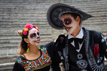 Portrait of mexican couple dressed as catrines. Day of the dead