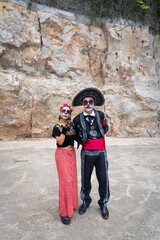 Couple dressed as mexican elegant catrines for day of the dead