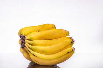 Bananas, a beautiful composition with bananas on a reflective surface with a light background, selective focus.