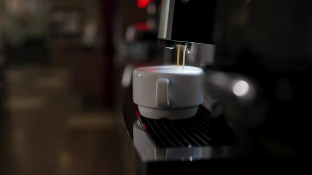 Americano preparation process. Espresso from a coffee machine. Coffee machine at the hotel buffet. Coffee machines make coffee without people. The coffee machine pours coffee into a glass.