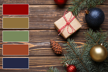 Green fir branches with Christmas decor and gift on wooden background. Different color patterns