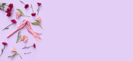 Flowers and whip for sex games on lilac background with space for text