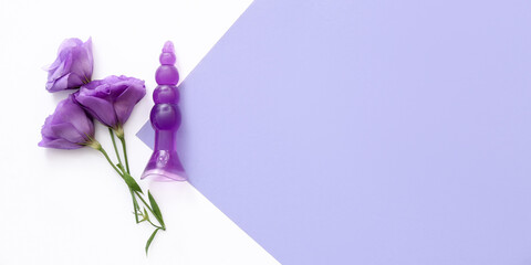Beautiful flowers and anal plug on color background with space for text