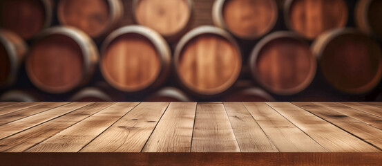 Wooden table in front of blurred oak barrel background, background of whisky and wine
