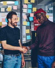 young men doing greeting gesture on meeting in coworking space for collaborating