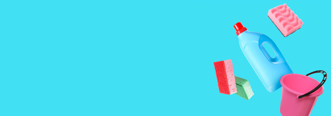 Flying cleaning supplies on light blue background with space for text