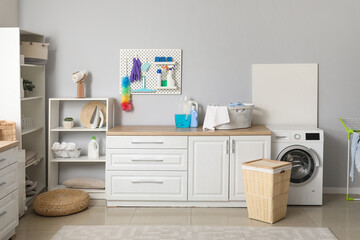 Interior of laundry room with pegboard and cleaning supplies - obrazy, fototapety, plakaty