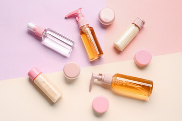 Set of many different travel cosmetic products on color background