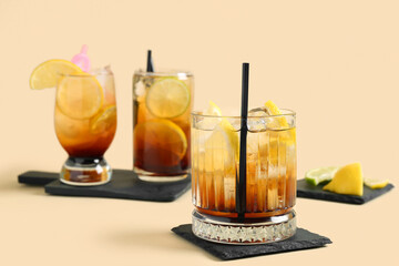 Glasses of delicious Long Island iced tea on color background