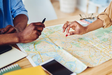 top view of checking directions for location using cartography on desktop
