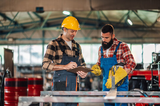 Two colleagues looking down to the notes before they start grinding.