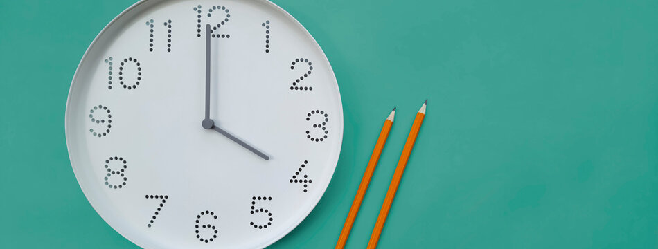 Banner with clock. 4 o'clock. Study time. Back to school. Watch with white clock face on table background with pencils. 4 pm. Concept of online study, deadline, schedule, workday. Header for website