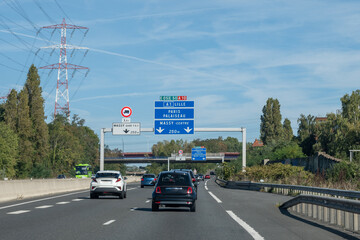Highway road signs Paris, driving in heavy traffic on ring road of capital of France, traffic jam...