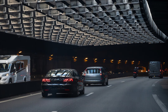 Driving in tunnel in heavy traffic on ring road of capital of France, traffic jam problems in Paris